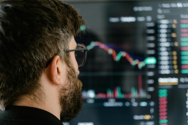 Trader looking at multiple crypto chart screens