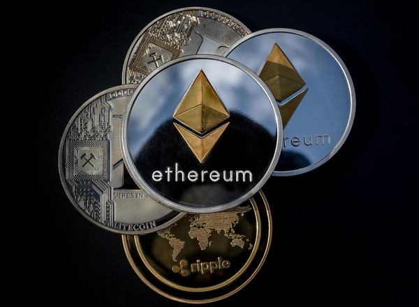 Silver Ethereum coins stacked with Ripple and Bitcoin coins