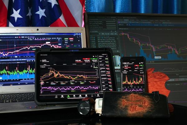 Several screens and tablets showing crypto trading charts
