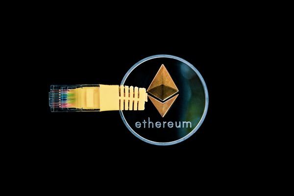 Ethereum coin connected to a yellow network cable