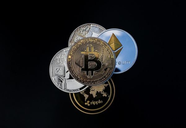 Cluster of Bitcoin, Ethereum and Ripple coins on a dark background