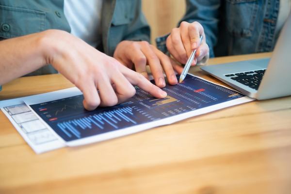 Hands reviewing a crypto price chart on a tablet