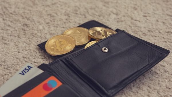 Leather wallet with gold crypto coins and bank cards