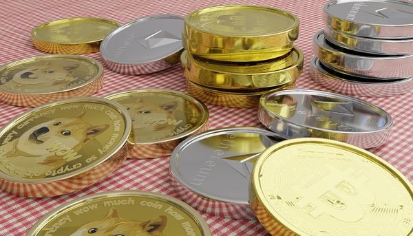 Stacks of gold and silver crypto coins on a checkered tablecloth