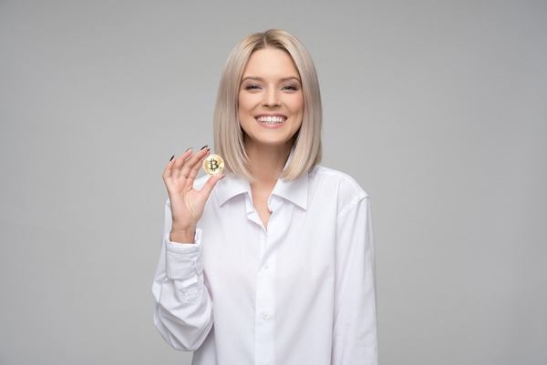 Smiling woman holding a gold crypto coin